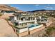 A modern multi-story home with an infinity pool is perched high upon a hillside at 641 Majestic Rim Dr, Henderson, NV 89012