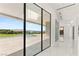 Bright hallway with pool view, marble floors and modern recessed lighting at 641 Majestic Rim Dr, Henderson, NV 89012