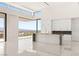 Bright kitchen featuring a marble island, custom white cabinetry, and oversized windows overlooking a city view at 641 Majestic Rim Dr, Henderson, NV 89012