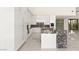Modern kitchen with a stylish island, sleek white cabinetry, stainless appliances, and marble countertops at 641 Majestic Rim Dr, Henderson, NV 89012