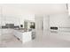 Open concept kitchen with a large island, white cabinetry, a modern fireplace, and polished floors at 641 Majestic Rim Dr, Henderson, NV 89012