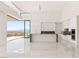 Modern kitchen features stone countertops, custom white cabinetry, and natural light at 641 Majestic Rim Dr, Henderson, NV 89012
