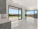 Open living area with marble floors, wet bar, and sliding doors to the outdoors at 641 Majestic Rim Dr, Henderson, NV 89012