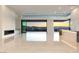 Stunning open living space with a fireplace, wet bar, and expansive sliding doors framing city views at 641 Majestic Rim Dr, Henderson, NV 89012