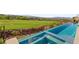 Infinity edge pool overlooking a lush golf course with a panoramic view of the surrounding landscape at 641 Majestic Rim Dr, Henderson, NV 89012