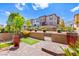 A backyard with a brick-paved area, green plants, landscaping, and a small artificial turf dog-run at 711 Florence Isle Ave, Henderson, NV 89015