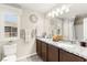 Elegant bathroom featuring double sinks, granite countertops, and stylish fixtures, offering a luxurious experience at 711 Florence Isle Ave, Henderson, NV 89015