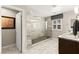 Modern bathroom features a spacious glass shower with rain shower head and bench at 711 Florence Isle Ave, Henderson, NV 89015