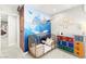 Stylized Bedroom with colorful Harry Potter themed decor, a cozy crib, and unique storage solutions at 711 Florence Isle Ave, Henderson, NV 89015