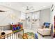 Charming bedroom with whimsical Harry Potter decor, ample natural light, and cozy furnishings at 711 Florence Isle Ave, Henderson, NV 89015