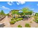 A manicured community space featuring shade structures, picnic tables, landscaping, and walking paths at 711 Florence Isle Ave, Henderson, NV 89015
