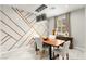 Elegant dining room featuring a modern chandelier and decorative accent wall with geometric wood trim at 711 Florence Isle Ave, Henderson, NV 89015