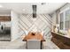 Dining room featuring modern lighting fixture, decorative wall, wooden table, and stainless steel refrigerator at 711 Florence Isle Ave, Henderson, NV 89015