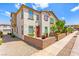Exterior of a two-story tan home with red shutters and a well maintained front yard at 711 Florence Isle Ave, Henderson, NV 89015
