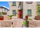 Welcoming front entry with a red door, landscaped yard, and a well-maintained brick pathway to the home at 711 Florence Isle Ave, Henderson, NV 89015