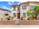 Beautiful two-story home with red shutters, a small yard, and a welcoming red front door at 711 Florence Isle Ave, Henderson, NV 89015