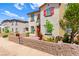 Charming two-story home with red shutters, a small yard, and inviting entrance at 711 Florence Isle Ave, Henderson, NV 89015