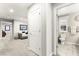 Hallway view leading to a full bathroom with natural light and modern fixtures at 711 Florence Isle Ave, Henderson, NV 89015