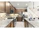 Modern kitchen featuring granite countertops, stainless appliances, and mosaic backsplash at 711 Florence Isle Ave, Henderson, NV 89015
