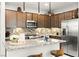 Modern kitchen with stainless steel appliances, granite countertops, tile backsplash, and pendant lighting at 711 Florence Isle Ave, Henderson, NV 89015