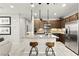 Well-lit kitchen featuring granite countertops, stainless steel appliances, and modern lighting at 711 Florence Isle Ave, Henderson, NV 89015
