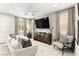 Bright living room featuring contemporary furnishings, a large TV, and neutral-toned decor at 711 Florence Isle Ave, Henderson, NV 89015