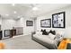 Upstairs living area features modern lighting, art, neutral decor, and comfortable seating at 711 Florence Isle Ave, Henderson, NV 89015
