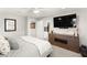 Spacious bedroom featuring a large bed, TV, and elegant contemporary furnishings at 711 Florence Isle Ave, Henderson, NV 89015