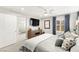 Main bedroom with a large bed, modern decor, and an ensuite bathroom at 711 Florence Isle Ave, Henderson, NV 89015