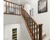 Carpeted staircase with wooden railing, connecting to upper level, and with view of lower pantry at 711 Florence Isle Ave, Henderson, NV 89015