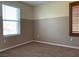 This carpeted bedroom features a neutral color palette and a large window at 7788 Soda Canyon St, Las Vegas, NV 89139
