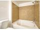 Bathroom featuring white bathtub and shower with a light brown wall surround and white tiling at 8000 Badura Ave # 1168, Las Vegas, NV 89113
