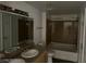 Bathroom featuring a double sink vanity, large mirror, and a shower-tub combination with tiled walls at 8000 Badura Ave # 1168, Las Vegas, NV 89113