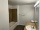 Bathroom with shower and tub combo with tan stone-look tile and vanity at 8000 Badura Ave # 1168, Las Vegas, NV 89113