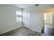 Bedroom with neutral walls, wood-look flooring, window with blinds and entry doors at 8000 Badura Ave # 1168, Las Vegas, NV 89113