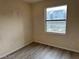 Empty bedroom with hardwood floors and a window at 8000 Badura Ave # 1168, Las Vegas, NV 89113