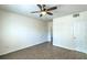 Bedroom with neutral walls, wood-look flooring, ceiling fan with light, and multiple entry doors at 8000 Badura Ave # 1168, Las Vegas, NV 89113