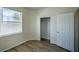 Bedroom with closet, window, and wood-look flooring at 8000 Badura Ave # 1168, Las Vegas, NV 89113