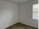 Bare bedroom with wood-look flooring and a window at 8000 Badura Ave # 1168, Las Vegas, NV 89113