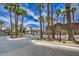 Gated community entrance with palm trees and lush landscaping at 8000 Badura Ave # 1168, Las Vegas, NV 89113