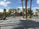 Community entrance with security gates surrounded by desert landscaping and mature palm trees at 8000 Badura Ave # 1168, Las Vegas, NV 89113