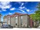 Building's exterior features neutral stucco, a covered parking, and well maintained landscaping for curb appeal at 8000 Badura Ave # 1168, Las Vegas, NV 89113