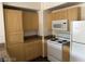 Functional kitchen with wooden cabinets, a white stove, and ample countertop space at 8000 Badura Ave # 1168, Las Vegas, NV 89113
