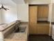 Kitchen featuring wood cabinets, granite countertops, stainless steel sink, and wood-look flooring at 8000 Badura Ave # 1168, Las Vegas, NV 89113