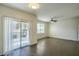 Living room boasts wood floors, ceiling fan, bright window, and sliding glass doors at 8000 Badura Ave # 1168, Las Vegas, NV 89113