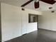 Open-concept living space features wood-look flooring, a doorway, and an installed ceiling fan at 8000 Badura Ave # 1168, Las Vegas, NV 89113