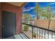 Patio features a privacy fence, black metal railing, and partial neighborhood views at 8000 Badura Ave # 1168, Las Vegas, NV 89113