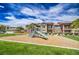 Community playground with slide and wood chip base surrounded by grass and landscaping at 8000 Badura Ave # 1168, Las Vegas, NV 89113