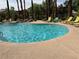 Beautiful community pool with lounge chairs and a decorative rock waterfall feature, perfect for relaxation at 8000 Badura Ave # 1168, Las Vegas, NV 89113