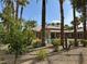 Community pool featuring palm trees, lounge chairs, and greenery at 8000 Badura Ave # 1168, Las Vegas, NV 89113